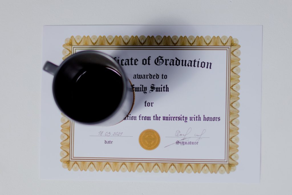 A cup of coffee on top of a certificate