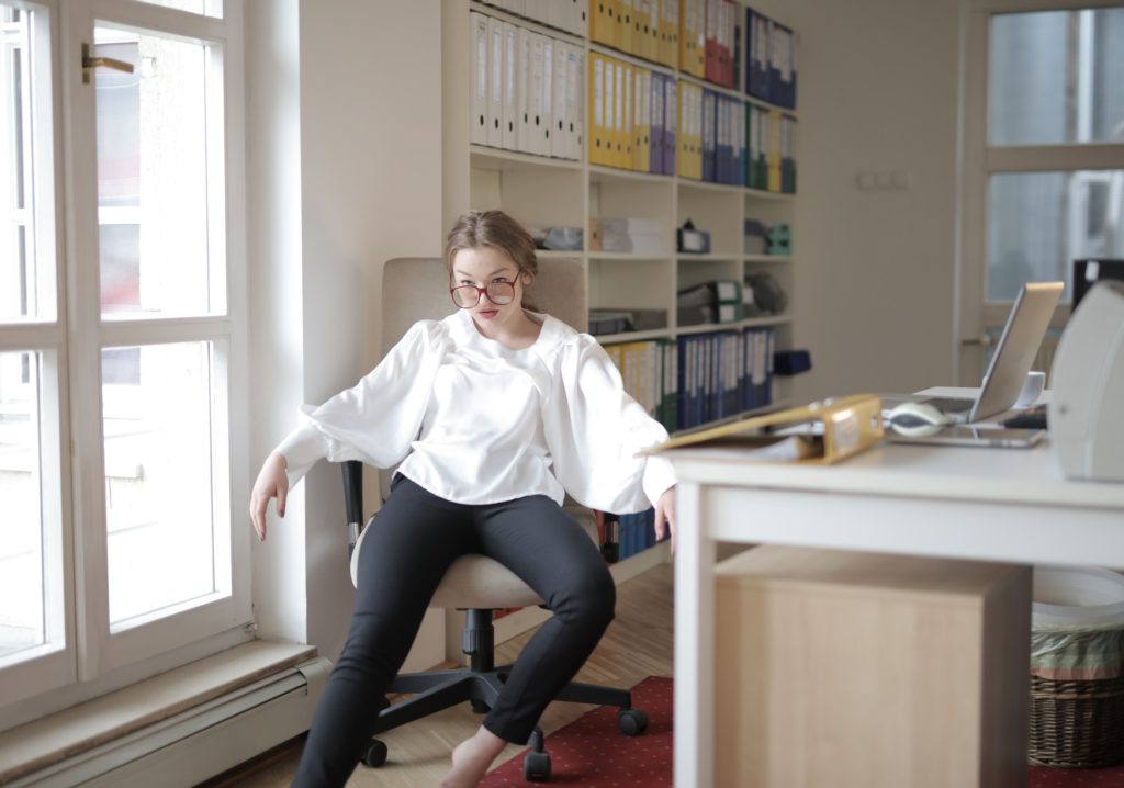 Arrogant female accountant slouching in her office chair