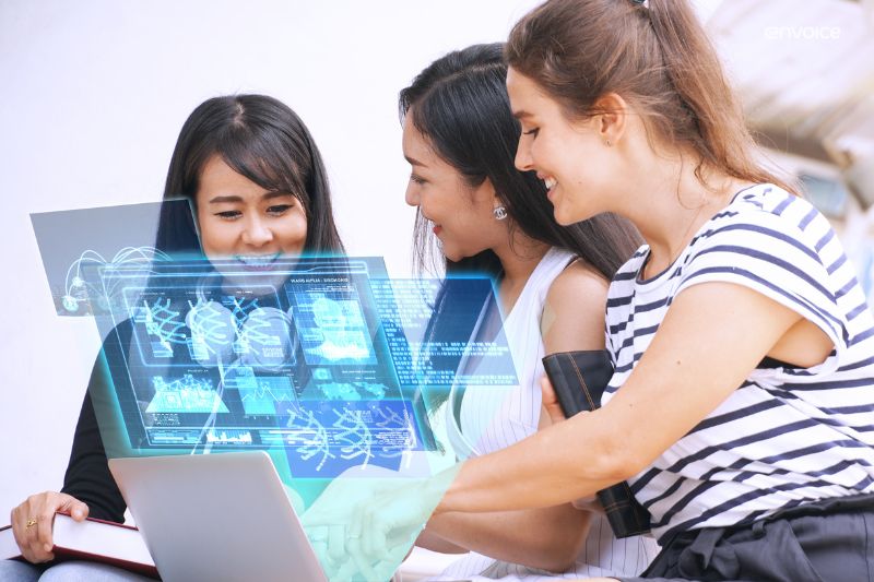 Three colleagues collaborating on a laptop with futuristic holographic visuals, showcasing innovation in paperless accounts payable systems