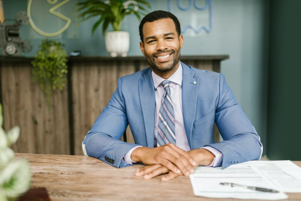 A smiling male accountant in a blue suit