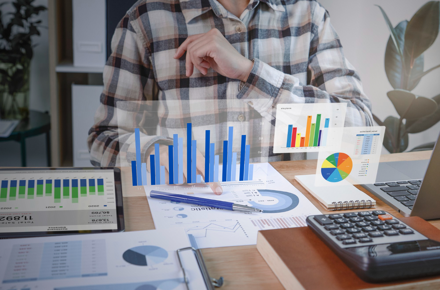 An accountant sitting at his desk with graphs and charts
