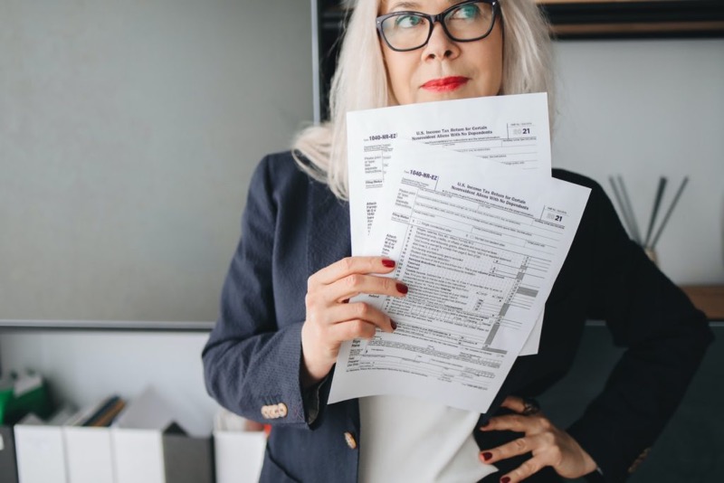 woman smiling holding financial papers
