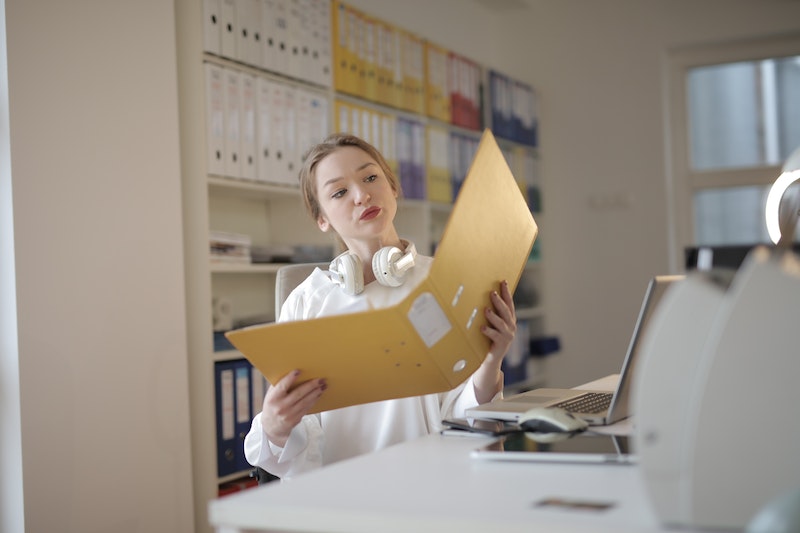 female office worker with folder in workplace