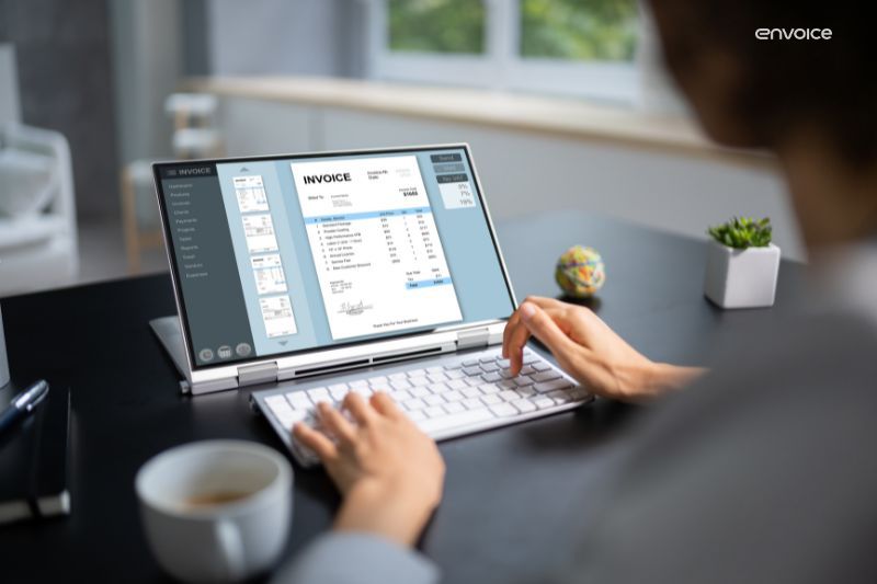 Automated invoice processing on a laptop screen as a user reviews digital invoices, streamlining financial workflows for businesses