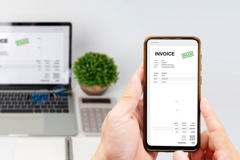 Automated invoice processing on a smartphone displaying a paid invoice, enhancing digital financial workflows and efficiency