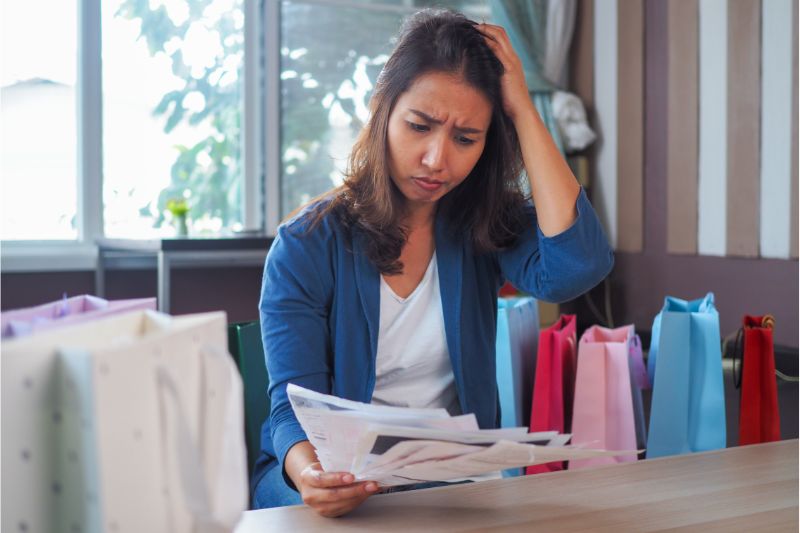 Woman reading document scratching head