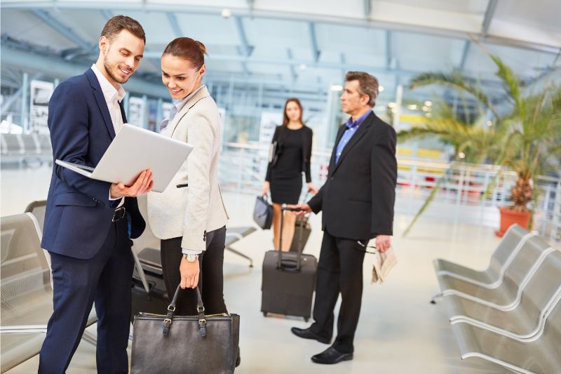 man using laptop at airport