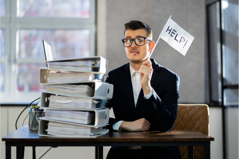 man asking help with stack folders on the table