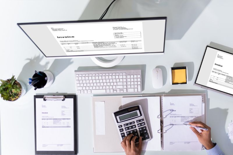 A person working with invoices, relevant to automated invoice scanning software
