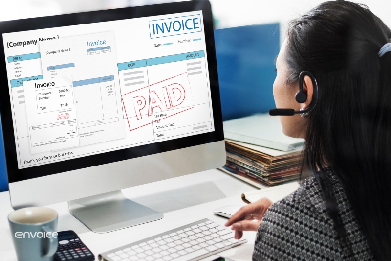 A customer service representative using automated invoice scanning software on a desktop to process and verify digital invoices efficiently.