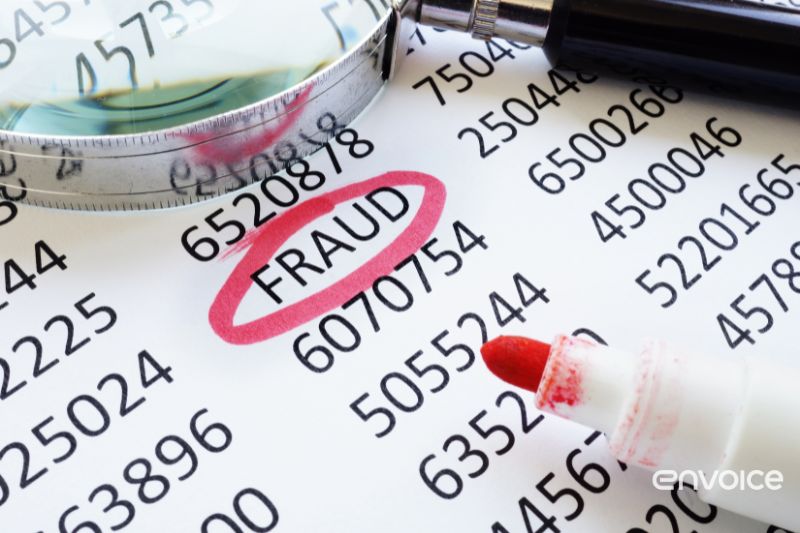 A magnifying glass and a red marker highlight the word "FRAUD" circled on a sheet filled with numbers