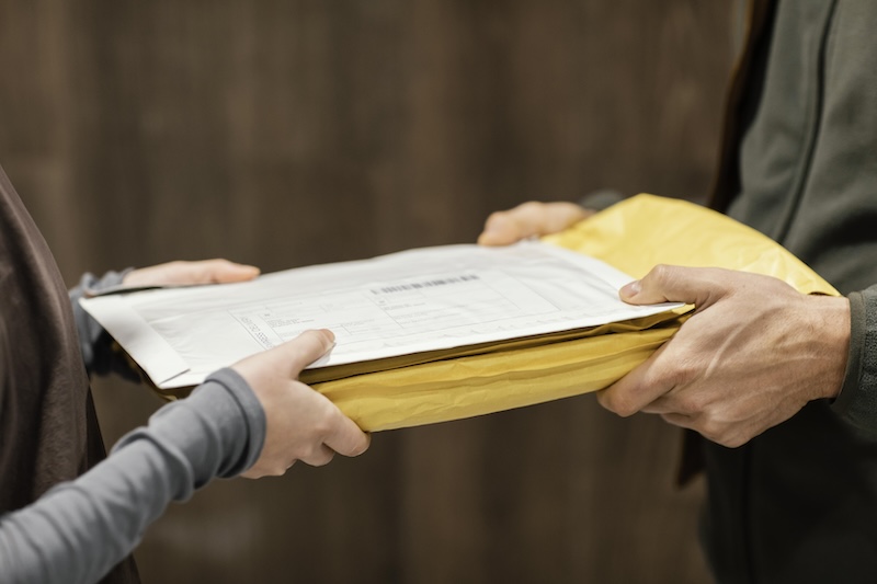 Business owner handing over Receipts for scanning