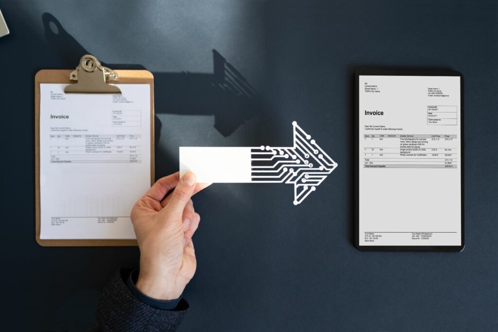 A person holding a blank business card with a circuit board pattern arrow pointing from left to right representing the process of transitioning from physical paperwork to digital solutions.