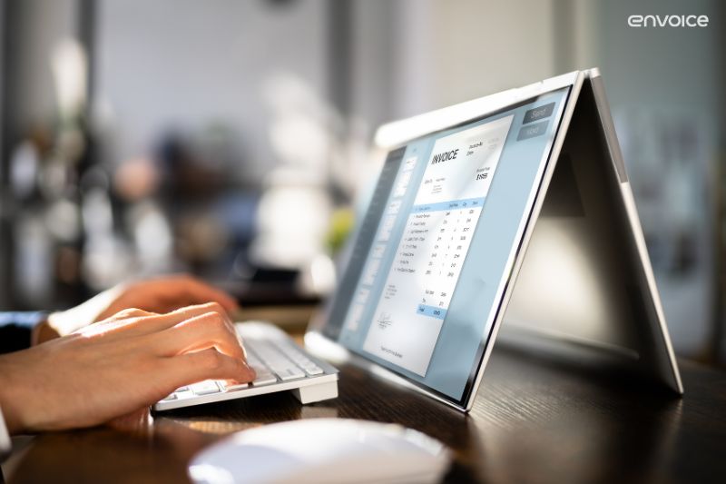 Hands using invoice recognition software on a tablet—exploring invoice recognition software for 2025 users
