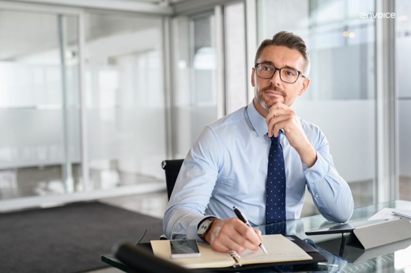 Businessman pondering software options—illustrating how to choose the right accounting software for your business