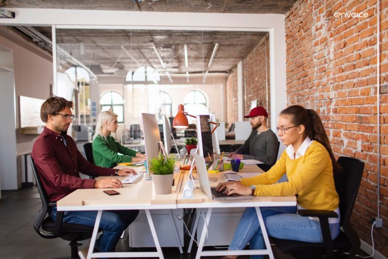 Modern office team working efficiently, boosted by AP automation machine learning tools.